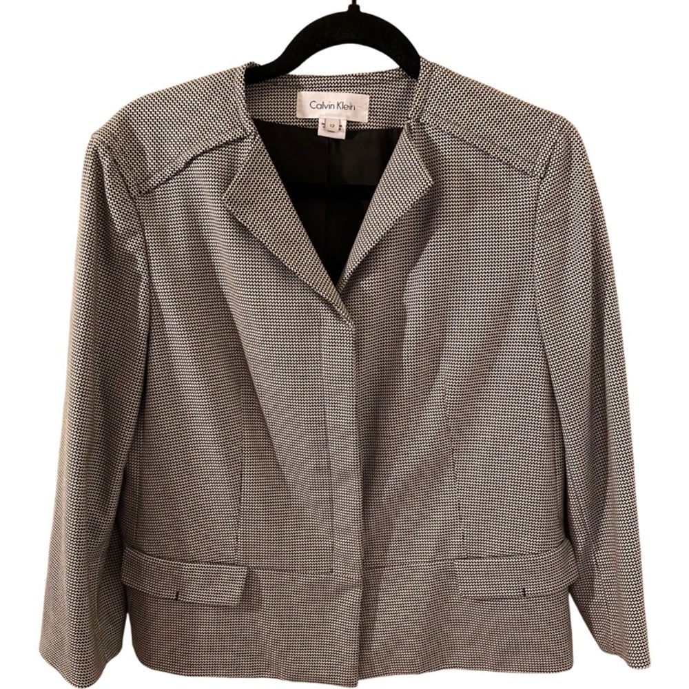 Calvin Klein lined blazer. Size 12. 3 button. Black/white. Decorative pockets.